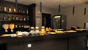 A bar area with shelves of liquor bottles, a clock, and a refrigerator.