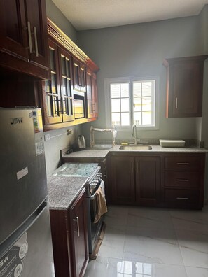 Private kitchen - Beautiful 2 bedroom , 2 full bathroom with pool on alongside bar and grill (Runaway Bay)