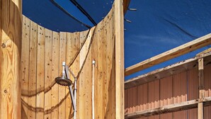 A wooden outdoor shower with a metal showerhead and a blue tarp overhead. - Yurt #9 - Glamping by the Gorge & Cave B (Quincy)