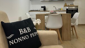 A modern kitchen with white cabinets, a gas stove, and a built-in oven. - Double room with private bathroom and balcony (Spoltore)