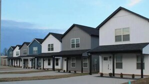 A row of modern single-family homes with gabled roofs and front porches. - Located in the Eli community of Russell Springs near Beautiful Lake Cumberland. (Russell Springs)