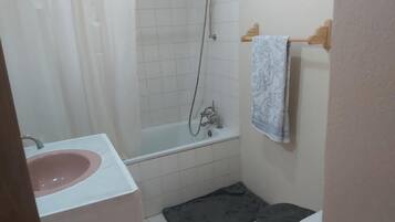 Combined shower/bathtub, towels, soap, toilet paper