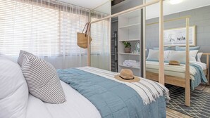A modern bedroom with a bed, a wardrobe, and a hanging basket. - Scandi Beach Breeze Minutes from Glenelg Beach (Glenelg)