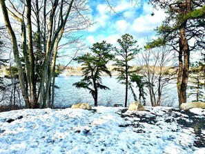 A snowy landscape with trees and a body of water. - Pocono Lakefront Villa-kayaks, firepl, skiing, gameroom+ (Long Pond)