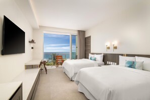 A hotel room with two beds, a TV, a balcony with a view, and a desk. - Clarita's Beach Bar & Resort, WorldHotels Elite (Jacó)