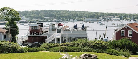 A waterfront property with a dock, a boat house, and a view of the marina.