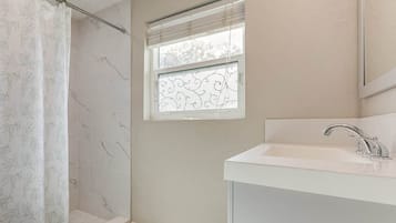Shower, hair dryer, towels, toilet paper