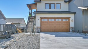 A modern two-story house with a large garage, a covered driveway, and a small outdoor area with construction equipment. - 1 Mi to Main Street: Extended Stay in Buena Vista! (Buena Vista)