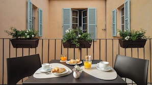 A table set for breakfast with croissants, a glass of orange juice, and a cup of coffee.