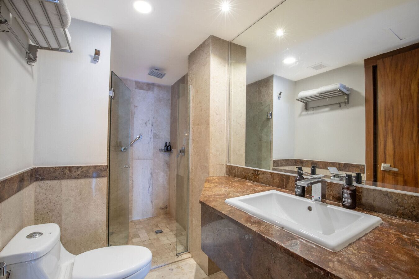 A bathroom with a shower, toilet, and sink.