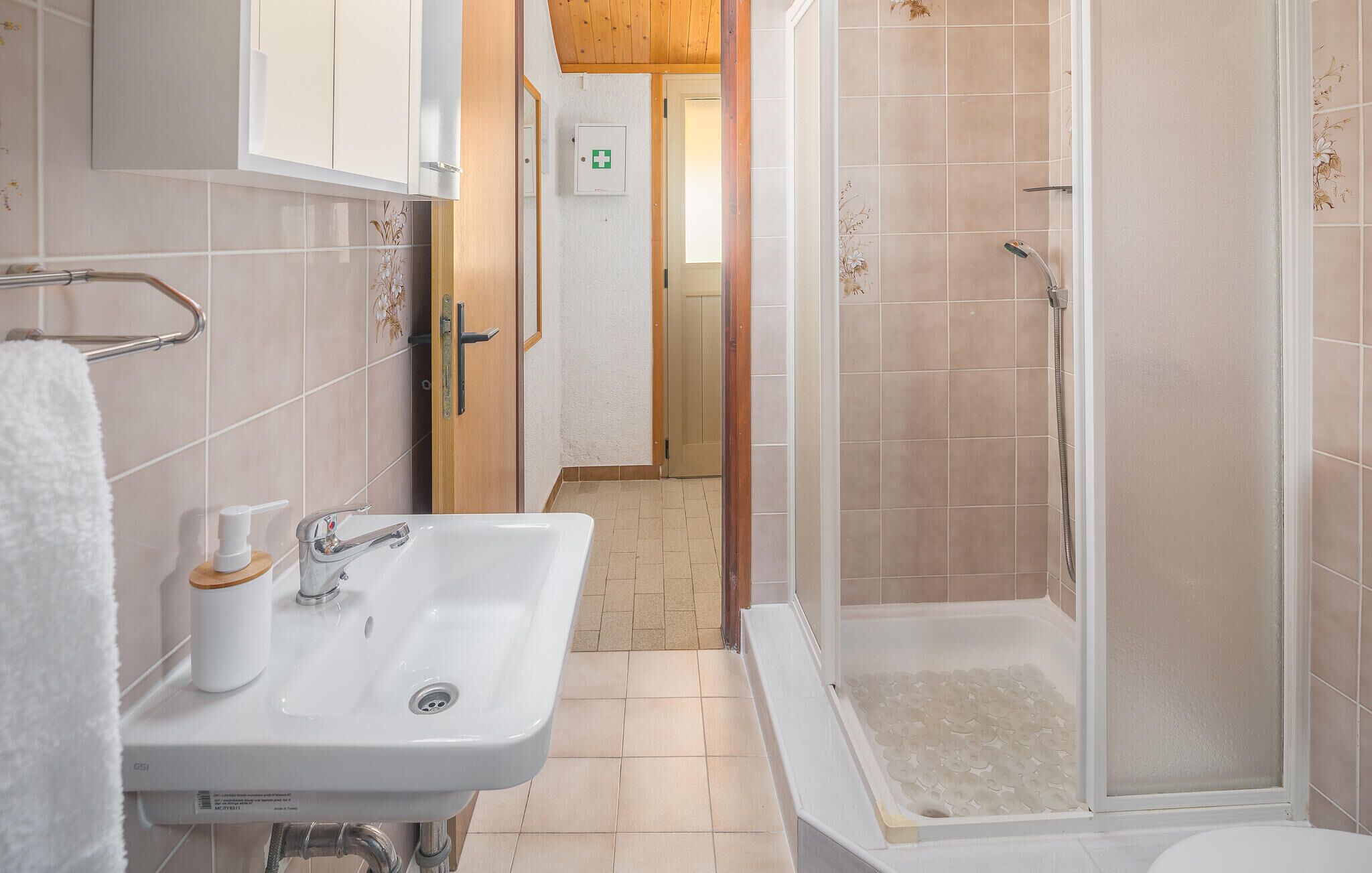 A bathroom with a sink, a shower, and a toilet.