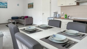 A modern kitchen with a built-in stove, a coffee machine, and a sink. - 2 bedroom pet friendly apartment in Cizici (Cizici)