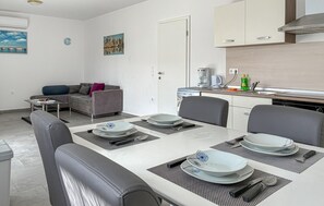 A modern kitchen with a built-in stove, a coffee machine, and a sink. - 2 bedroom pet friendly apartment in Cizici (Cizici)