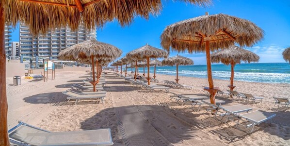 On the beach, sun-loungers, beach towels