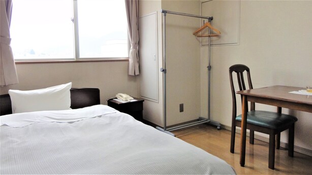 A hotel room with a bed, a desk, a chair, a wardrobe, and a window. - Hotel Stay Inn San Annex (Yamagata)