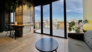 A modern interior with a dining area, a round table, and a sofa.