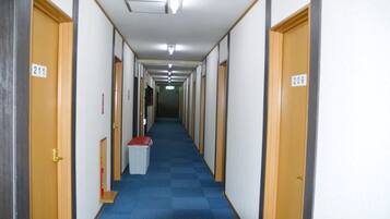 A long, narrow hallway with doors numbered 211 and 209, leading to rooms.