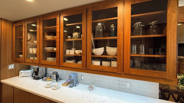 A kitchen with wooden cabinets, a marble countertop, and various kitchen appliances. - Charming Valley Home, Close to Top LA Attractions; Lovely 3-bedroom house (Los Angeles)