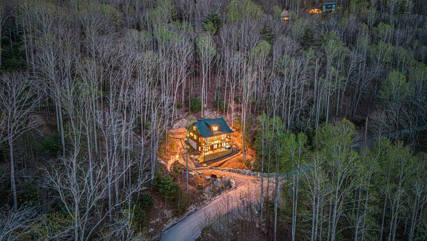 A lodge surrounded by forest with a clear road leading to it. - Luxury MTN Retreat | Hot Tub | Fire Pit | Game Rm (Fleetwood)