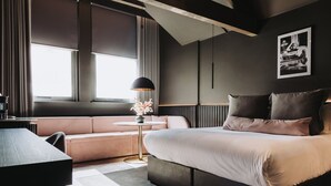 A modern bedroom with a bed, a sofa, a round table, and a window with curtains. - Velvet Hotel Manchester, Worldhotels Crafted (Manchester)