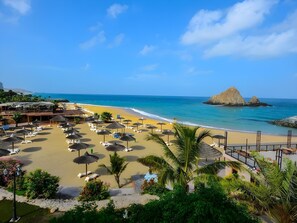 A beach resort with sun loungers, umbrellas, and a pool area. - Sandy Beach Hotel Resort (Al Aqah)