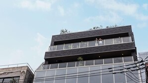 A multi-story building with a modern architectural design, featuring large windows and balconies. - H Daimyo (Fukuoka)