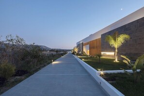 A modern building with a concrete pathway leading to a well-lit entrance. - D Andrea Lagoon - Adults Only (Kos)