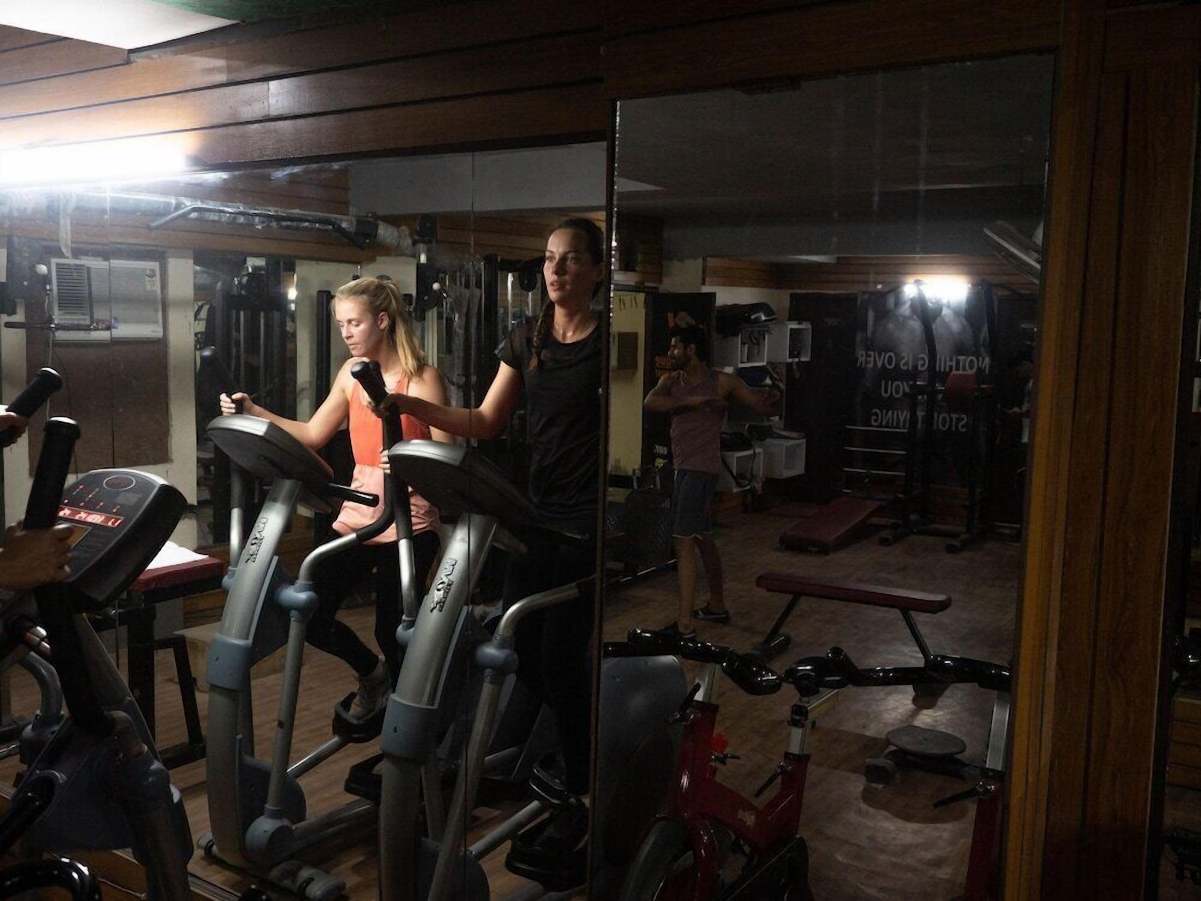 A gym with stationary bikes, a treadmill, and weight machines.