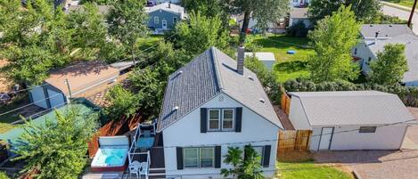 A residential property with a two-story house, a fenced backyard, and a swimming pool.
