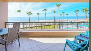 A balcony with a view of the beach and a pool. - Oceanfront Sunsets at Sonoran Spa E305 (Puerto Peñasco)