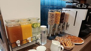 A breakfast buffet with various food items and beverages. - Hotel de la Marne (Lyon)
