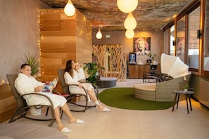 A spa area with seating, a reception desk, and a mural on the wall. - Domaine DE LA Foret D Orient Natur Hotel Golf SPA (Rouilly-Sacey)