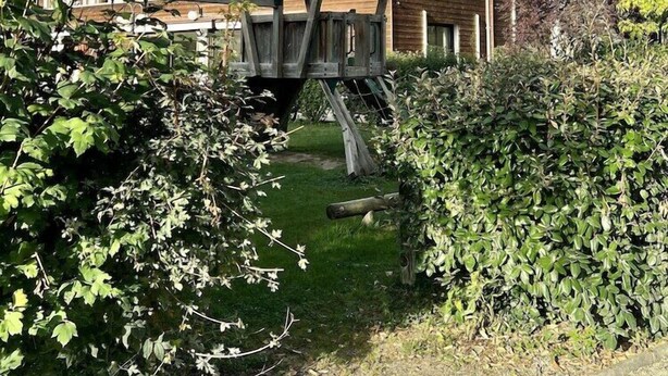 A large, multi-story wooden building with a symmetrical facade and arched windows. - Domaine de La Foret D Orient Natur Hotel Golf Spa (Rouilly-Sacey)