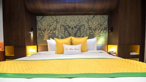 A hotel room with a large bed, floral wallpaper, and two bedside lamps. - Zone By The Park Jodhpur (Jodhpur)