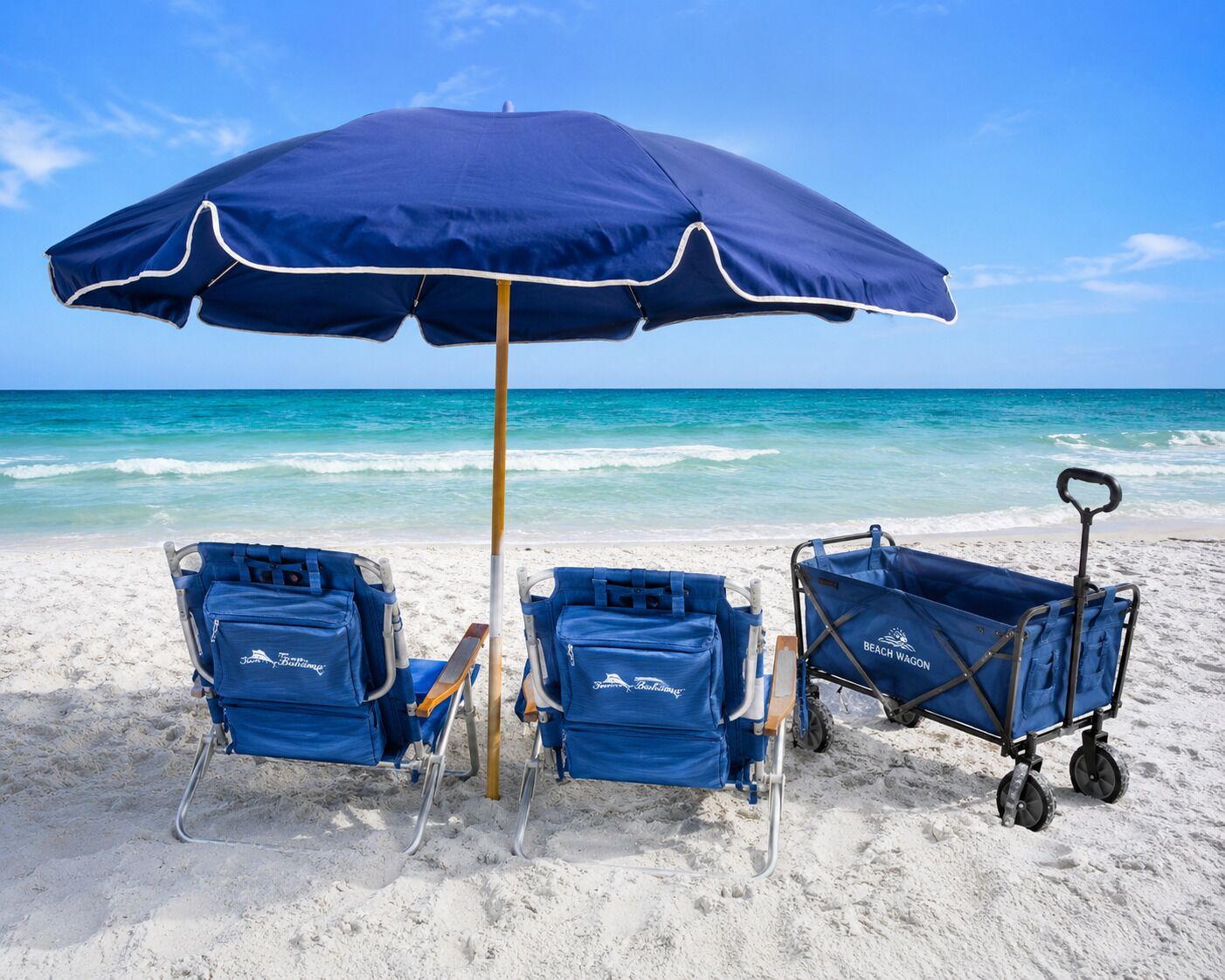 A beach scene with two beach chairs, a beach umbrella, and a beach wagon.