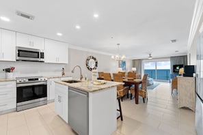 A modern kitchen with white cabinets, stainless steel appliances, and a central island. - Beachfront~2 King Suites~Sunset Balcony~Family Resort w/Pool (Destin)
