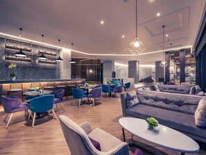 A modern lounge area with seating, a bar, and a staircase. - Mercure Shanghai Necc (Shanghai)
