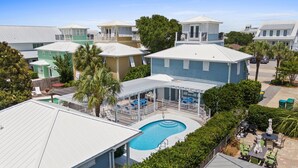 A residential area with a swimming pool, covered patio, and various houses. - Steps to Beach~Private Pool~Pet Friendly~Carriage House~Optional Golf Cart! (Destin)