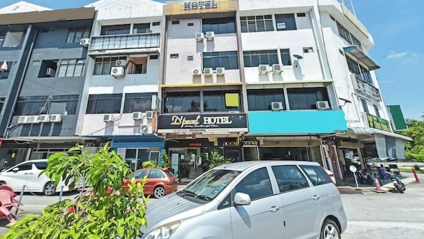 A hotel building with multiple floors, air conditioning units, and a sign for 'Hotel'. - D'pearl Hotel (George Town)