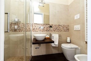 A modern bathroom with a glass shower enclosure, a white sink, and a toilet. - B&B Chez Moi (Bologna)
