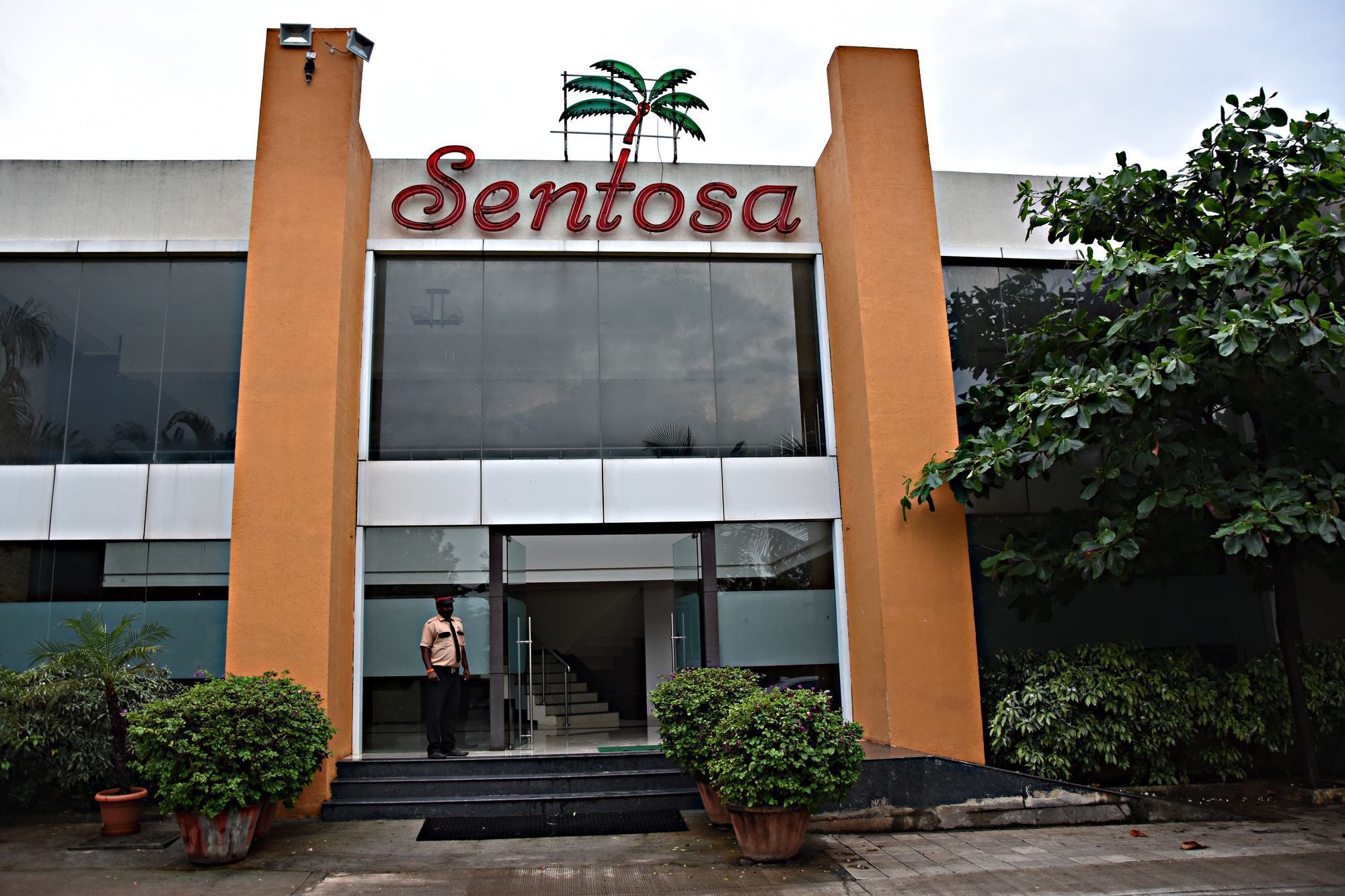 A building with a large sign reading "Sentosa" above the entrance.