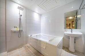A modern bathroom with a bathtub, shower, and sink. - 1 Night 2 Days Hotel (Yangsan)