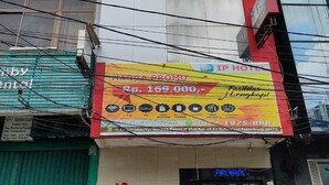 A hotel with a prominent sign advertising a promotional price. - Sentra Hotel (Palembang)