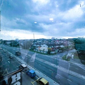 A cityscape with a road, buildings, and a cloudy sky. - New Wave Hotel Seri Kembangan (Seri Kembangan)