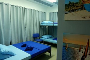 A room with bunk beds, a chair, and a bed with a blue blanket. - Mactan-cebu Airport Budget Hotel (Lapu-Lapu)