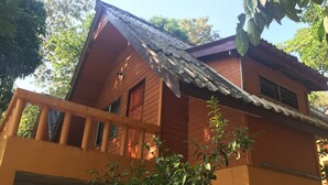 A two-story wooden house with a balcony, a visible staircase, and a window. - Banhalawee (Phang Nga)