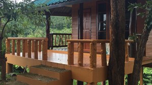 A wooden structure with a balcony, steps, and a door. - Banhalawee (Phang Nga)