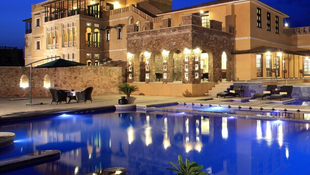 A large, multi-story hotel with a pool area. - Juna Mahal Jungle Resort Ranthambore (Sawai Madhopur)