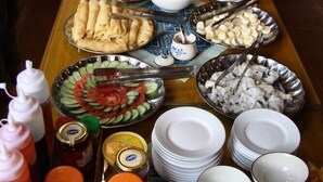A buffet table with various dishes and condiments. - Mai Chau Nature Lodge - Hostel (Mai Chau)