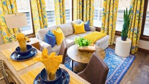A living room with a sofa, coffee table, and decorative items.